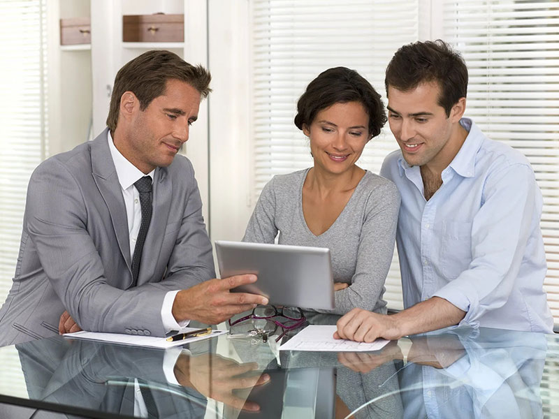 a salesperson discussing with a couple